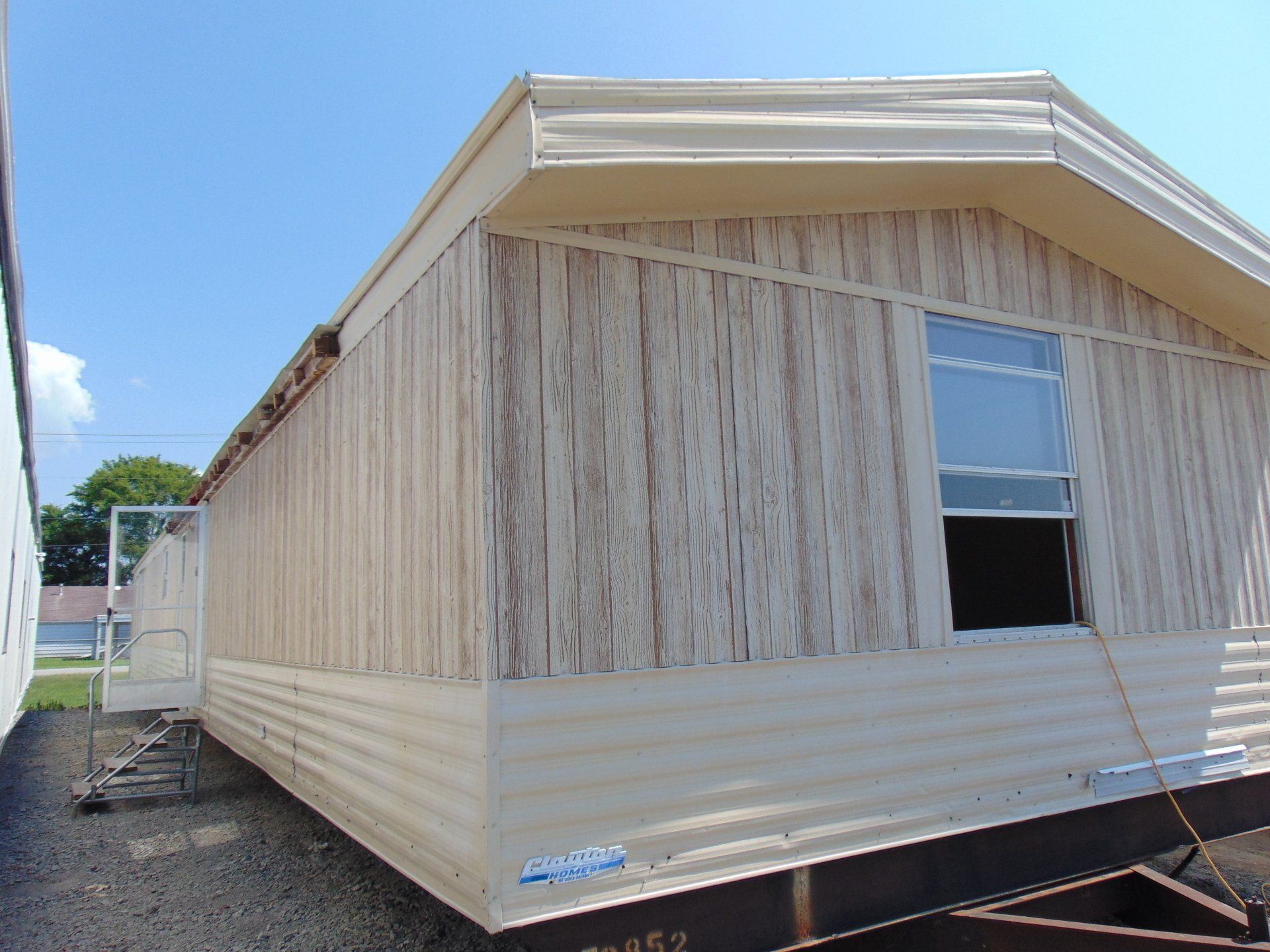 A mobile home with a staircase leading up to it