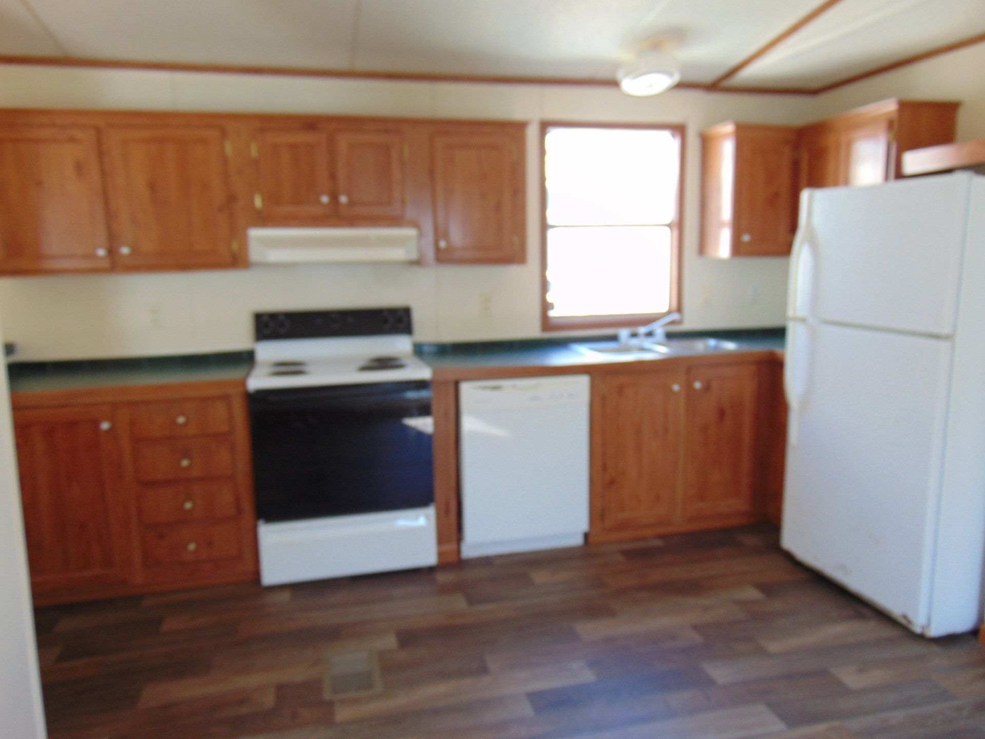 A kitchen with wooden cabinets and a white refrigerator