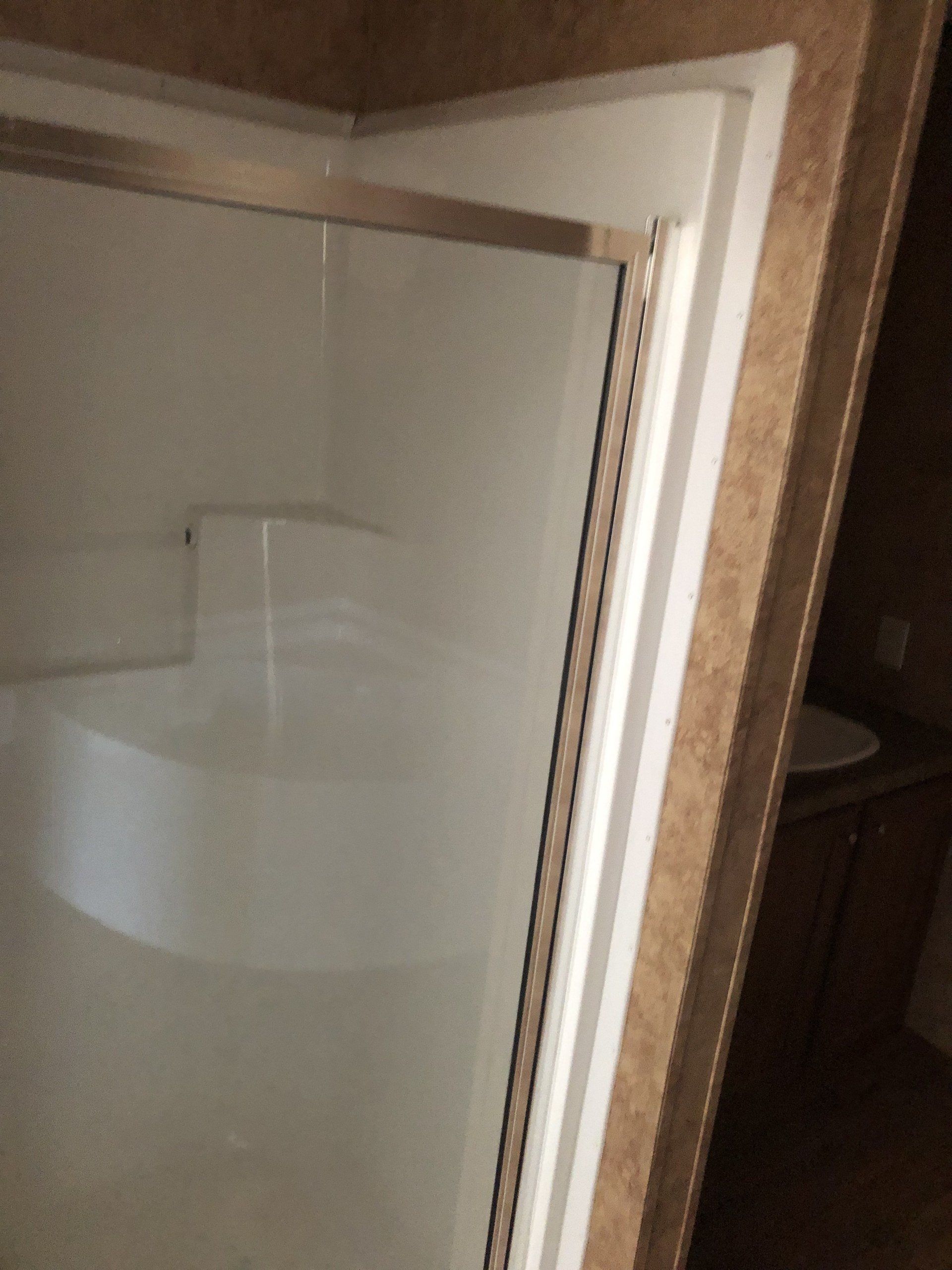 A bathroom with a bathtub and a shower stall