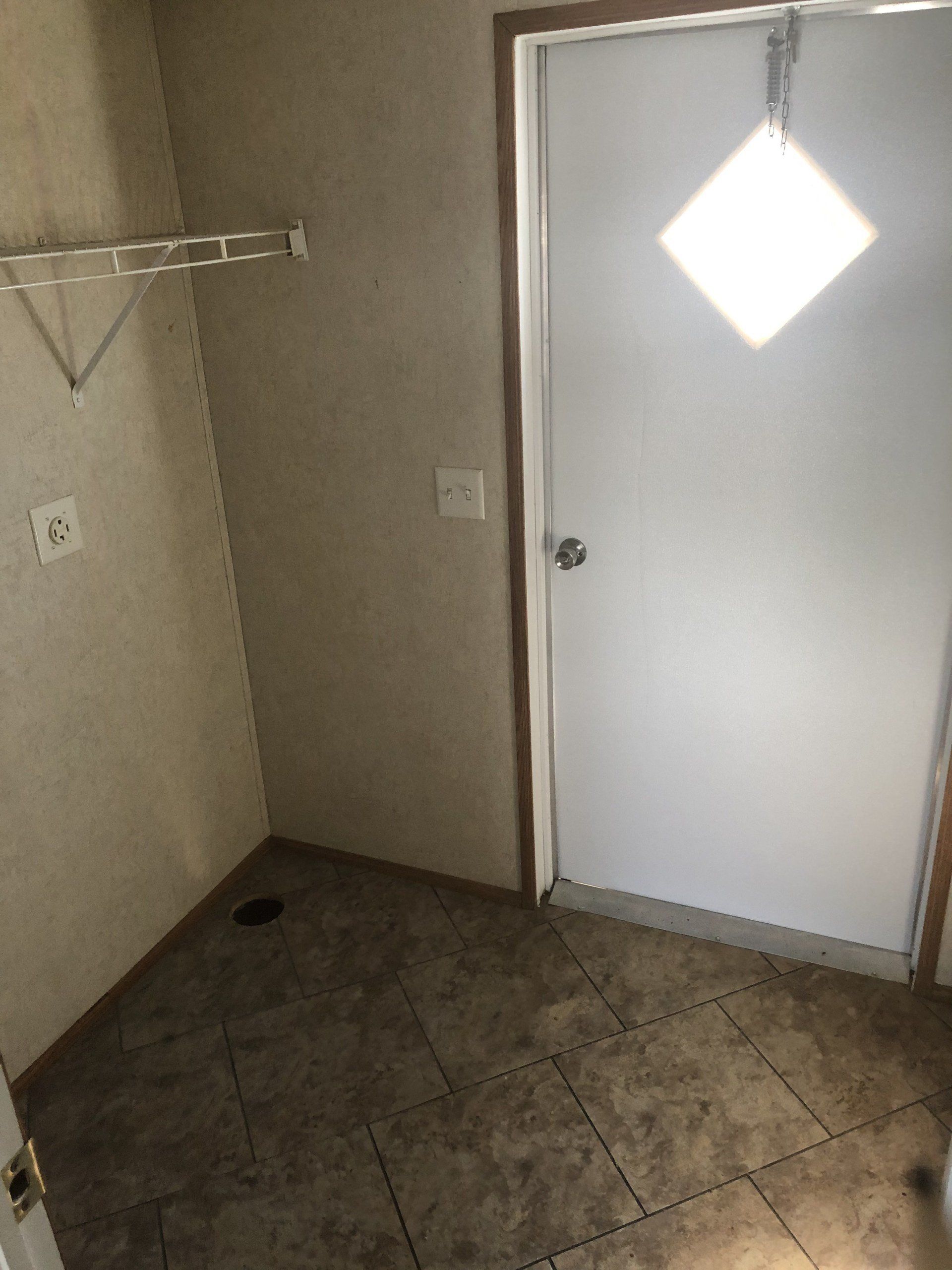 A room with a door and a light on the ceiling