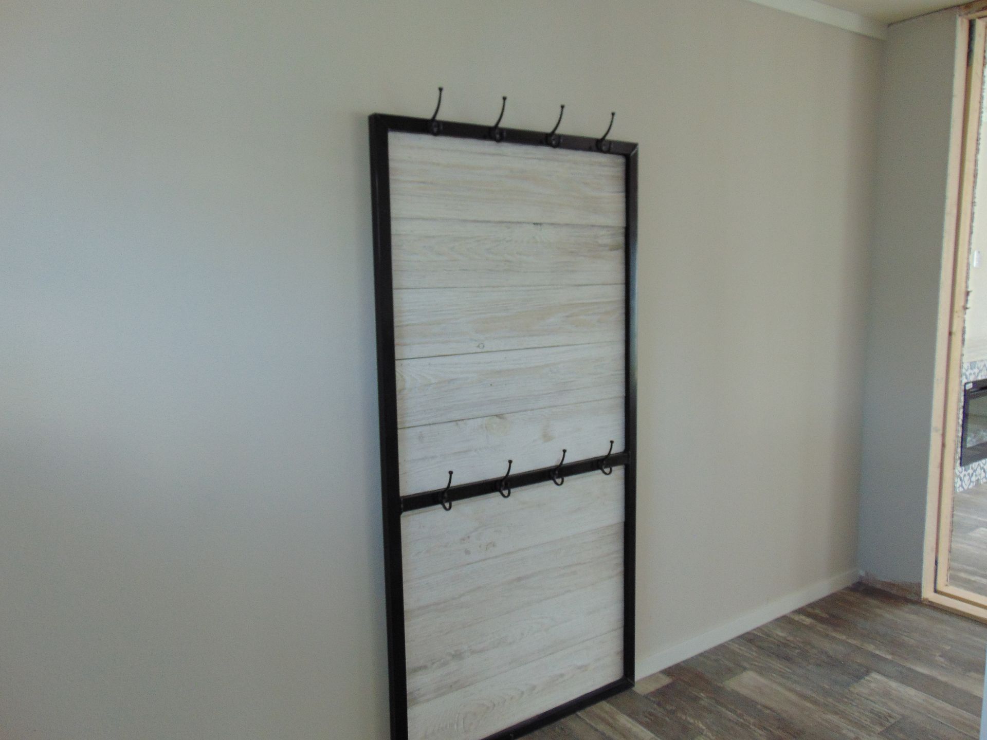 a coat rack is hanging on a wall in a room