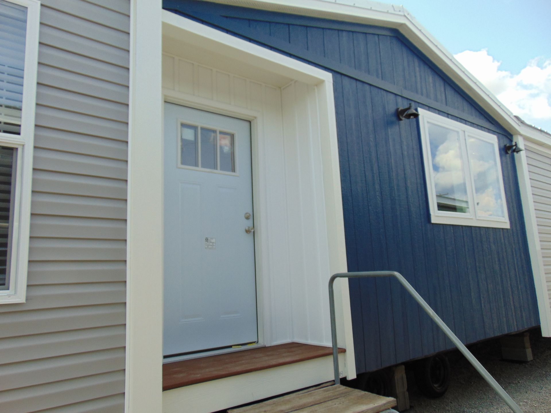 a blue house with a white door and windows