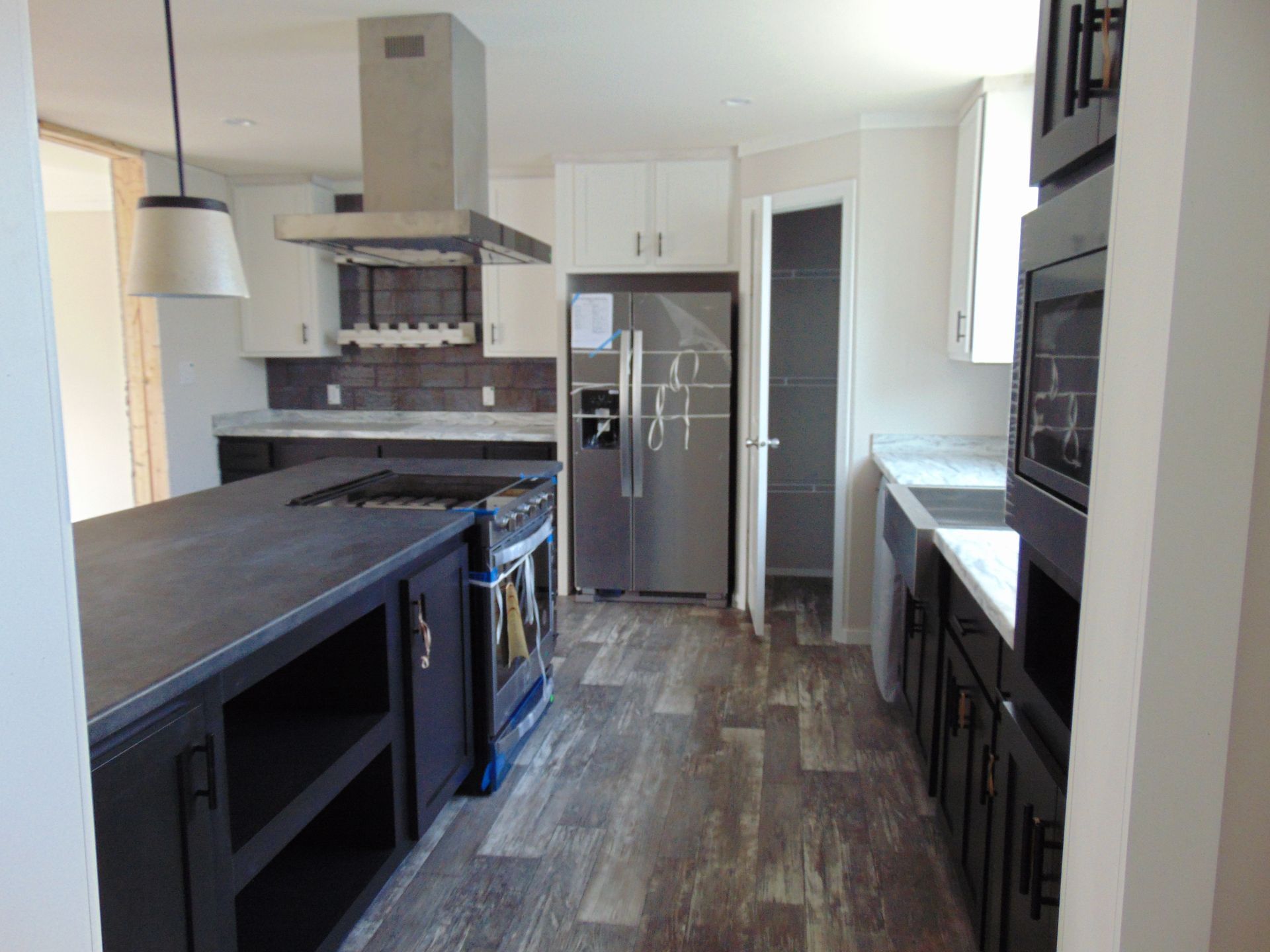a kitchen with stainless steel appliances and black cabinets