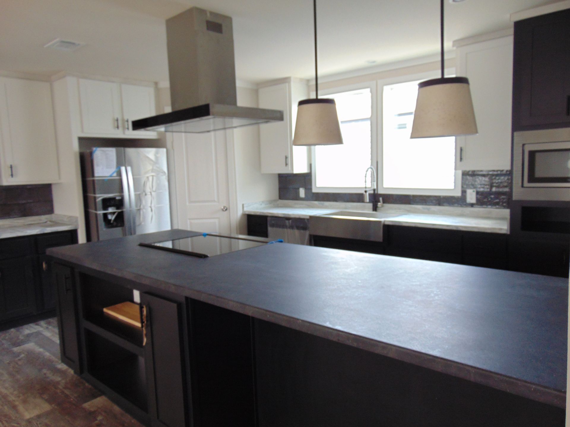a kitchen with stainless steel appliances and a large island
