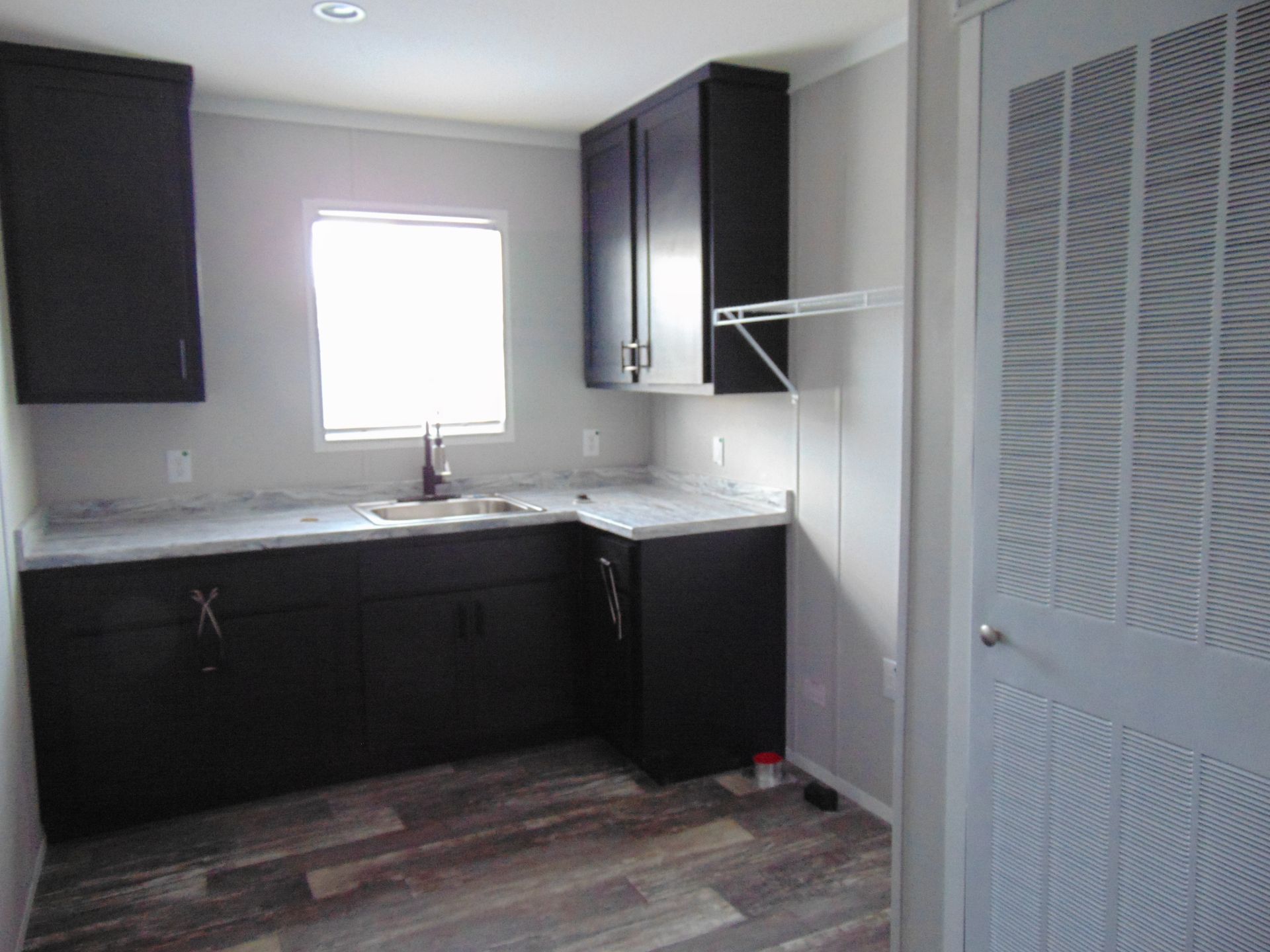 a kitchen with black cabinets