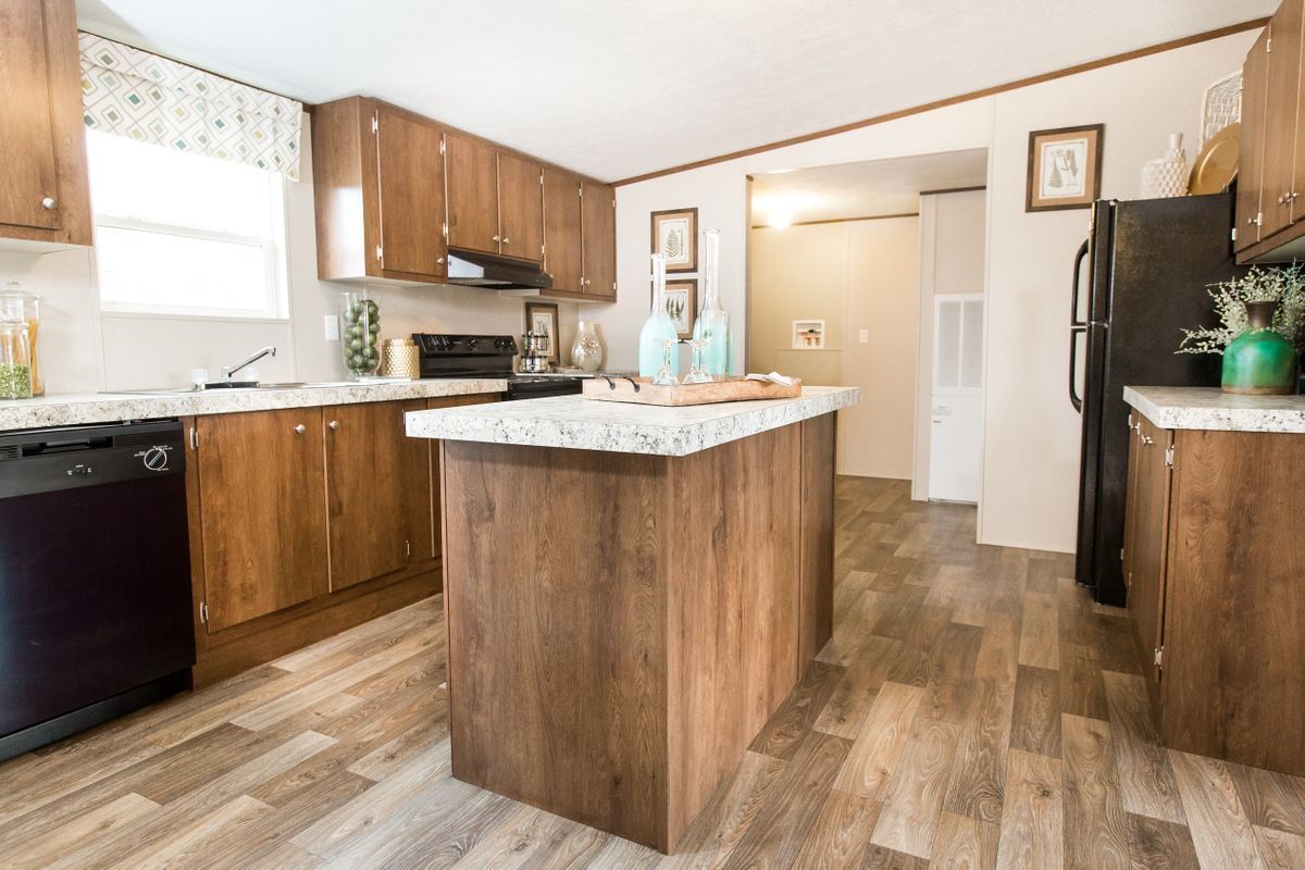 a kitchen in a mobile home with a large island in the middle
