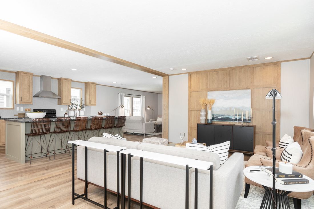 a living room filled with furniture and a kitchen in a house