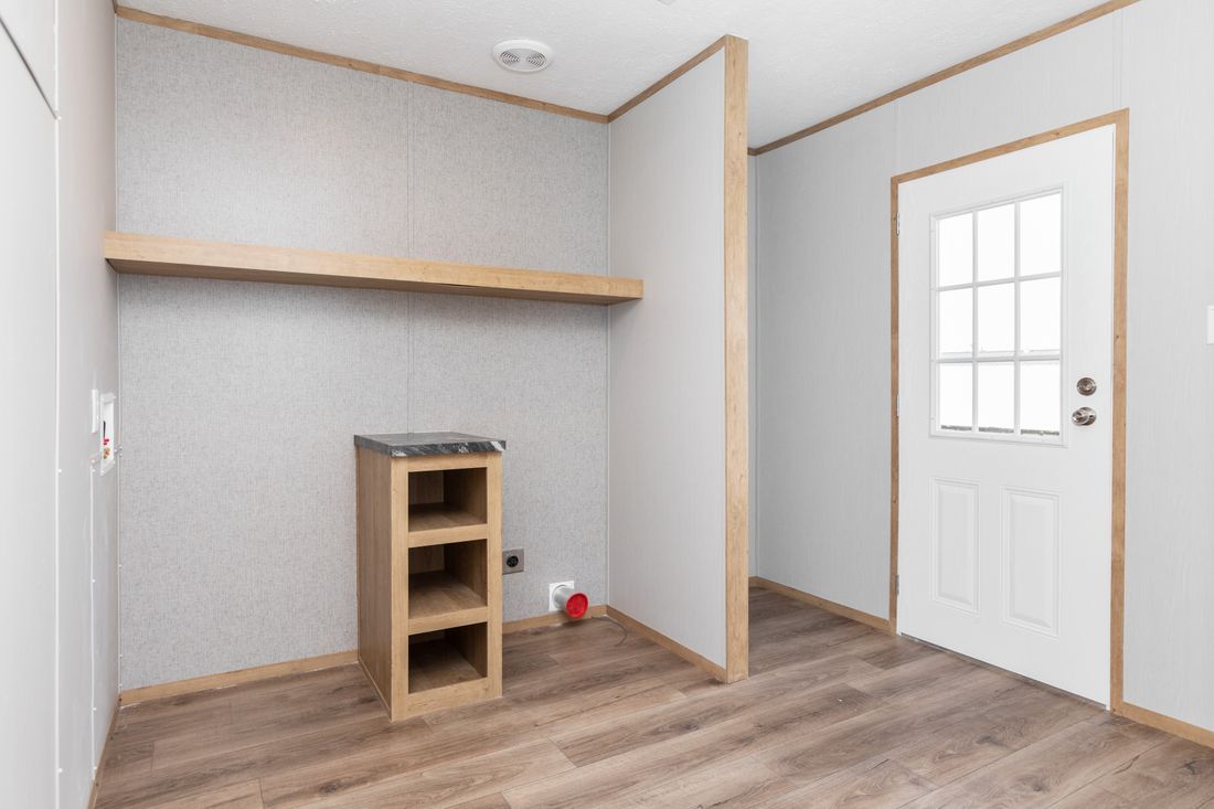 an empty room with a wooden floor and a white door