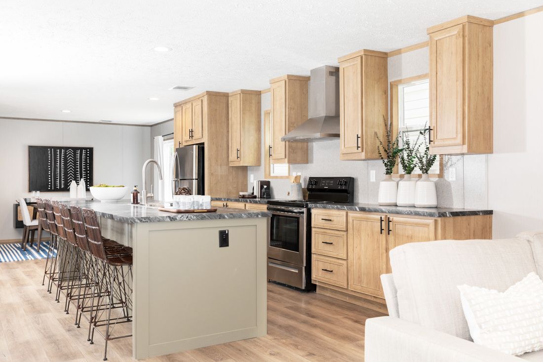 a kitchen with wooden cabinets, stainless steel appliances, and a large island