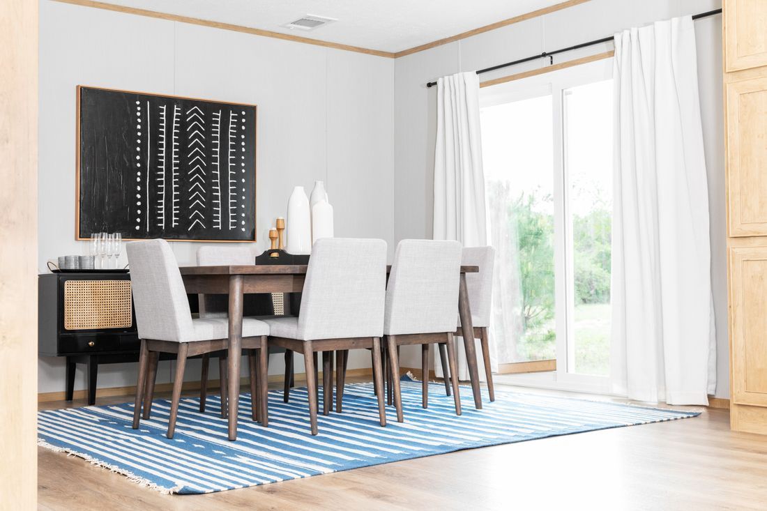 a dining room with a table and chairs and a rug