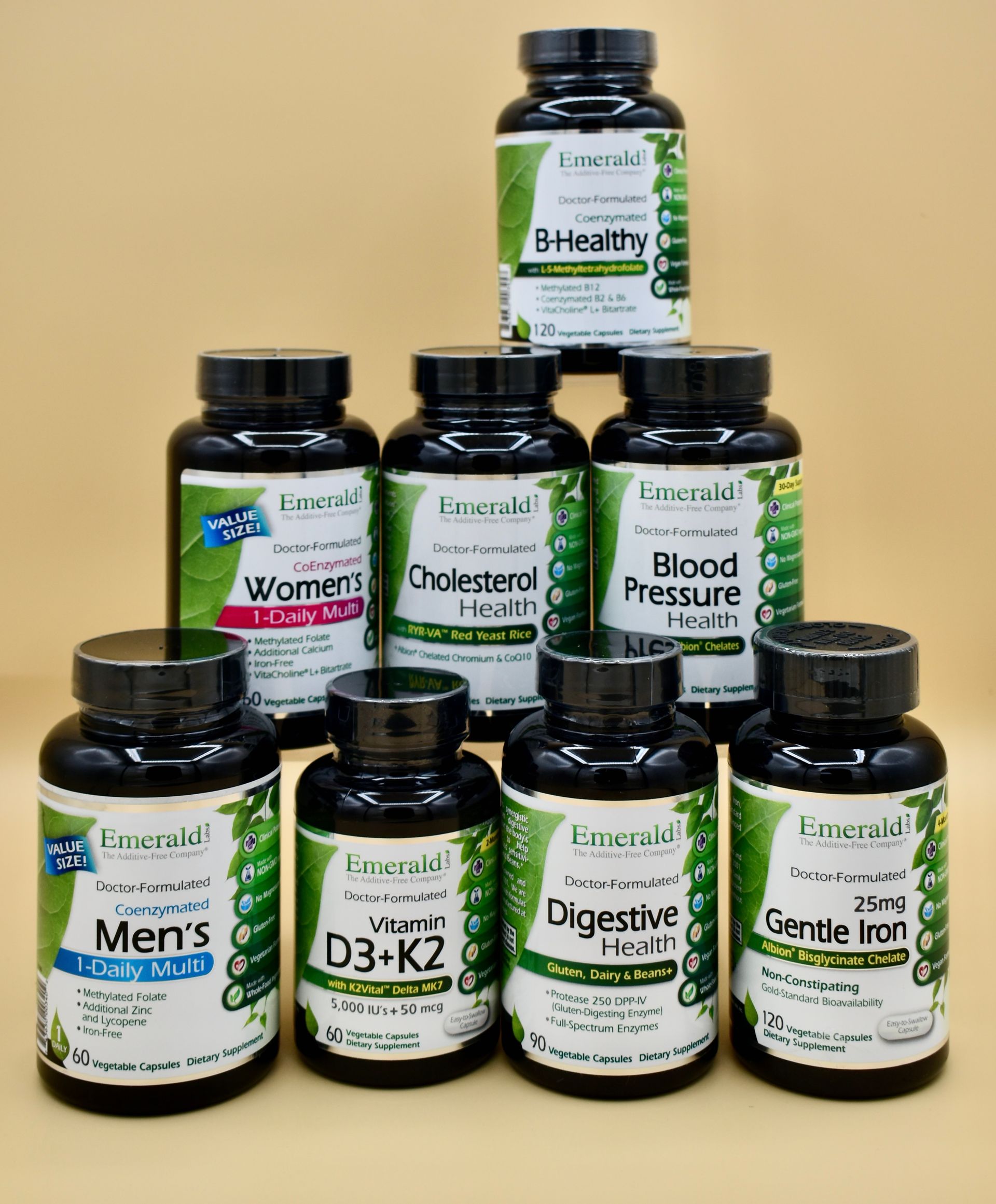 Stacked wellness supplement bottles on a beige background