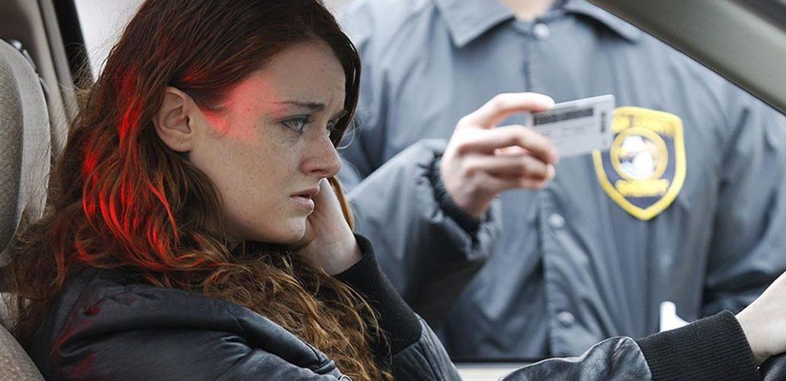 Worried woman inside a car