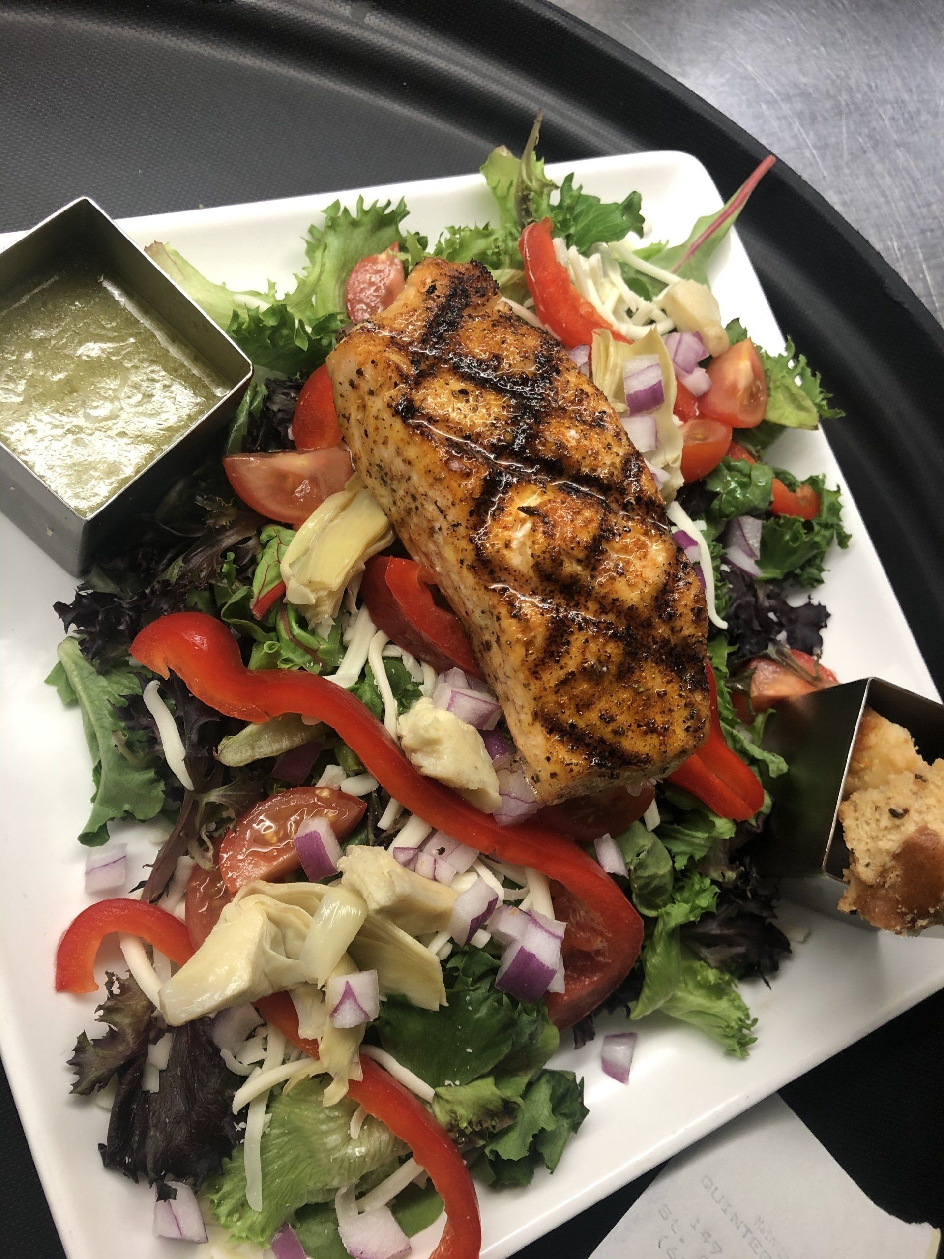 A salad with meat and vegetables on a white plate