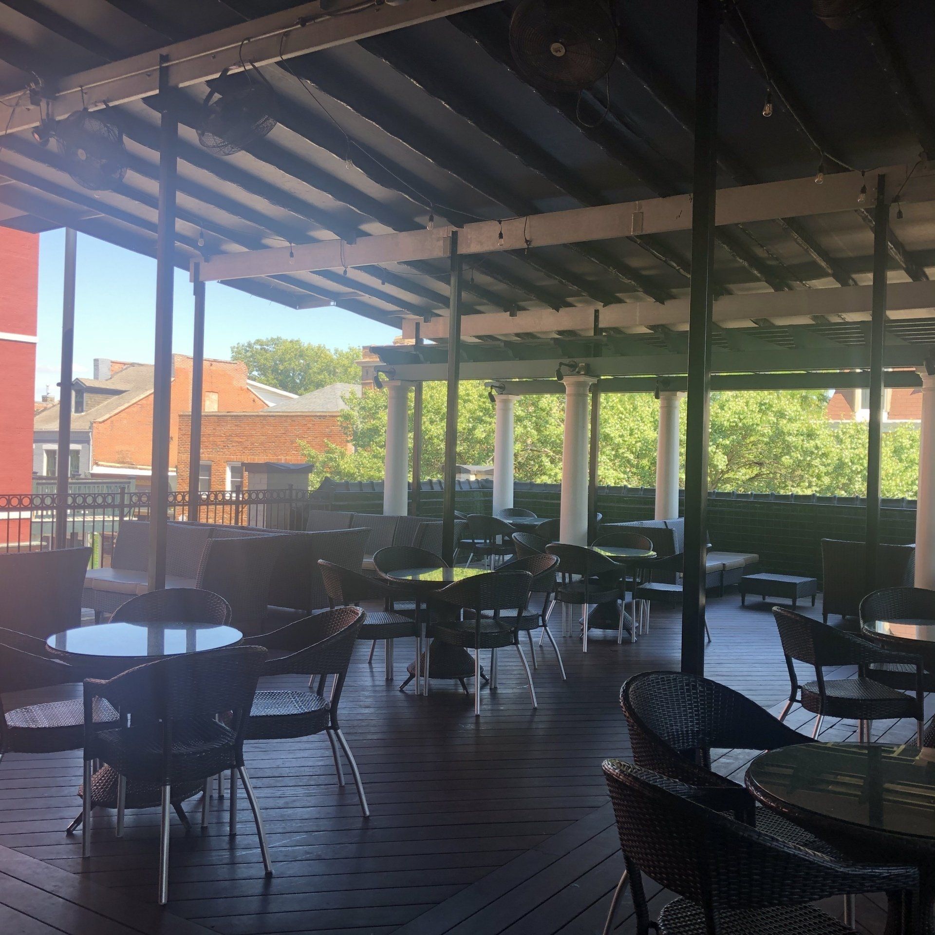 A restaurant with tables and chairs under a canopy