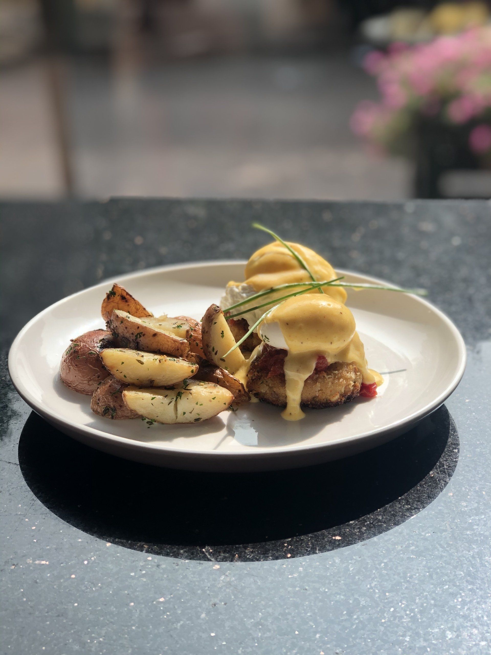 A plate of food with potato wedges on a table.