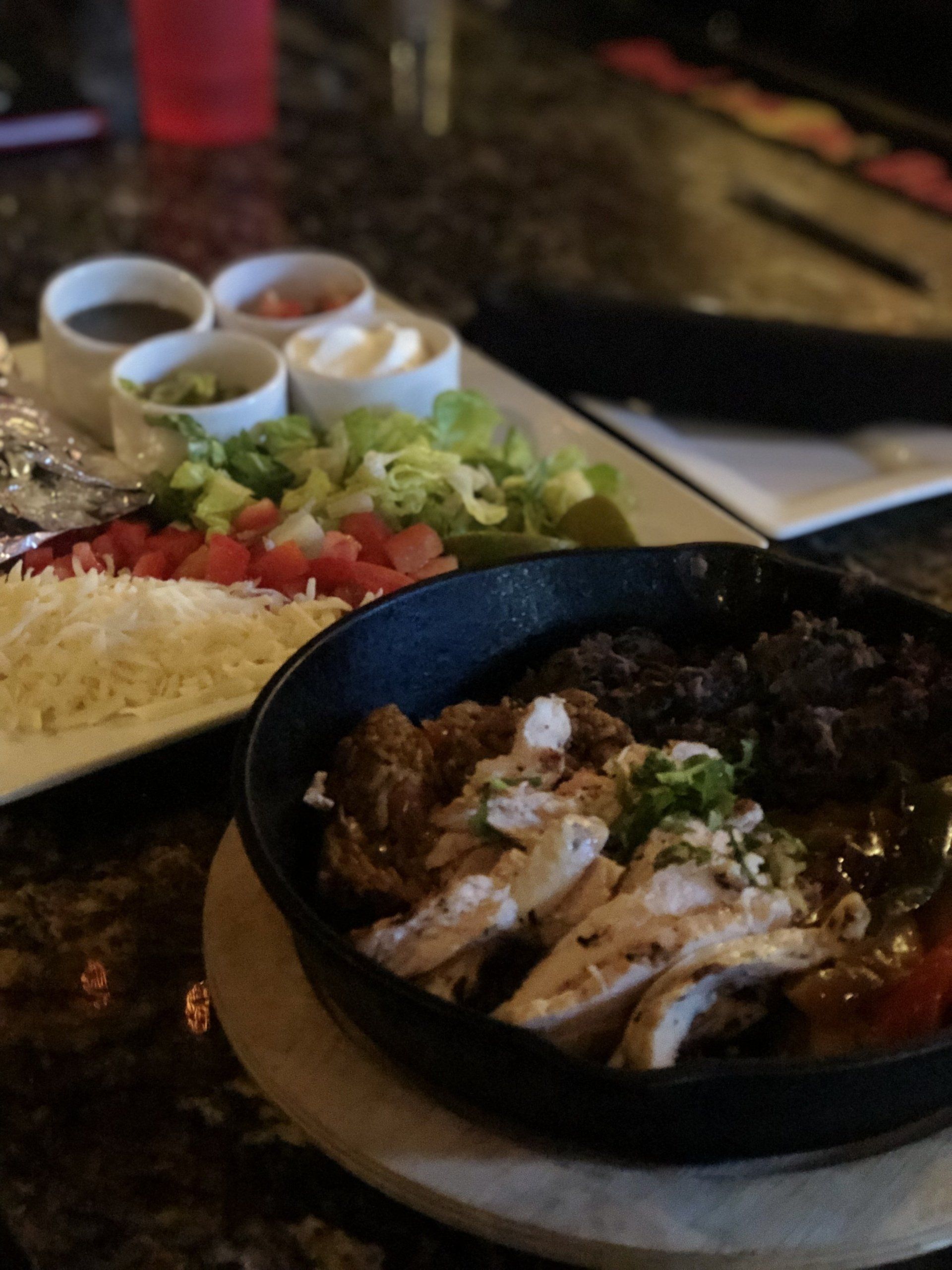 A plate of food with meat and vegetables on a table