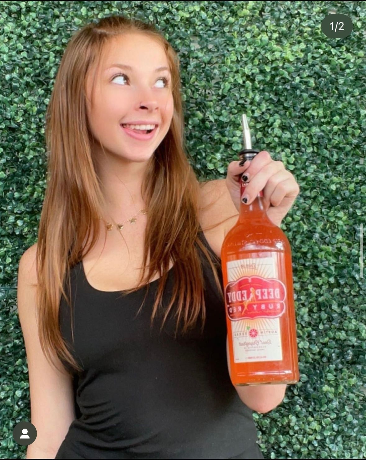 woman posing with a deep eddy bottle