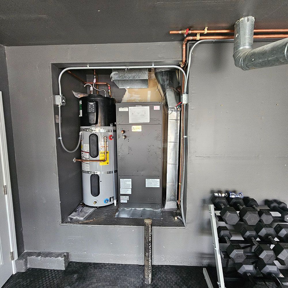 Water heater and HVAC unit recessed in a gray wall, next to a dumbbell rack.