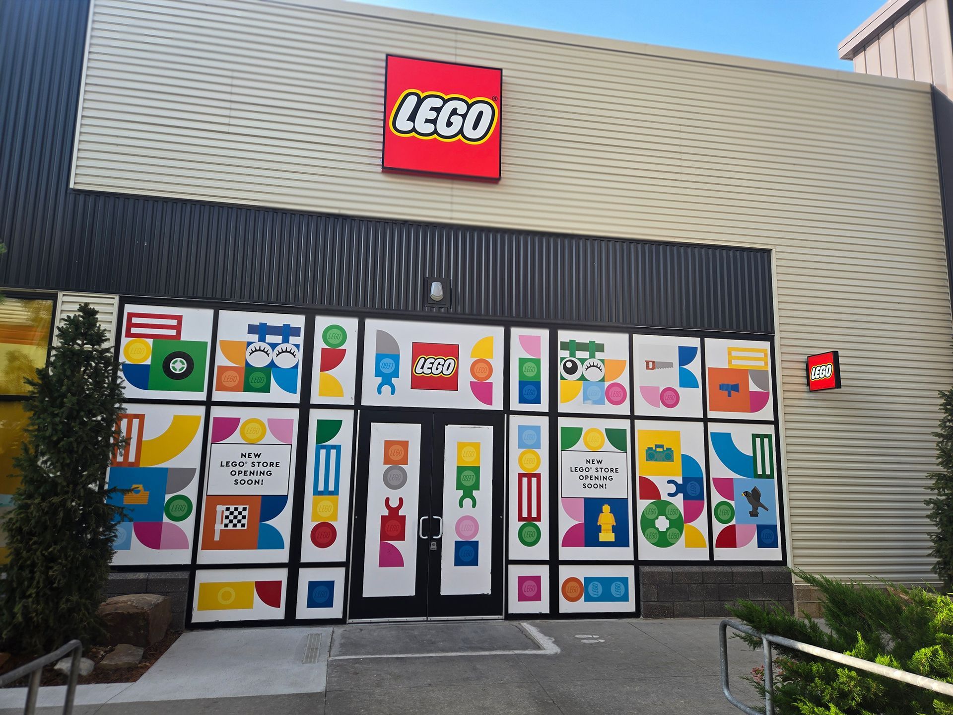 LEGO store entrance with colorful toy-themed window display panels