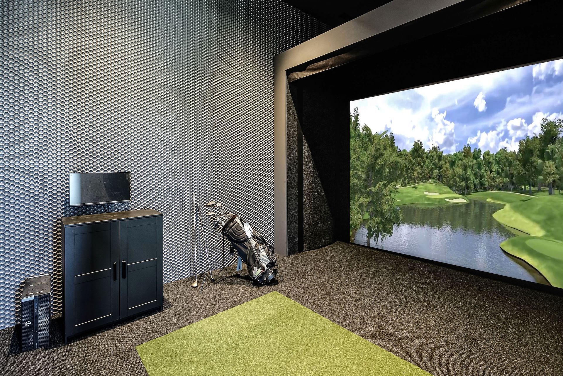 Modern room with patterned wall, black fireplace, green rug, and large nature landscape screen