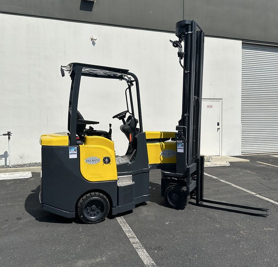 A yellow and black forklift is parked in a parking lot
