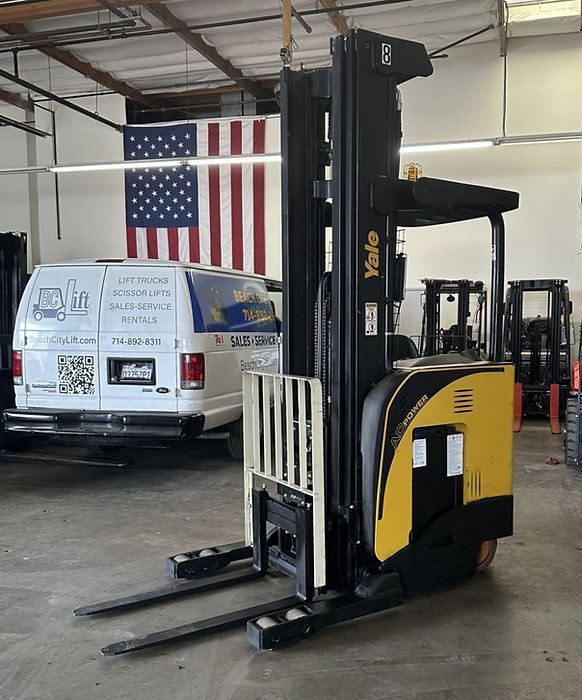 A yale forklift is parked in front of an american flag