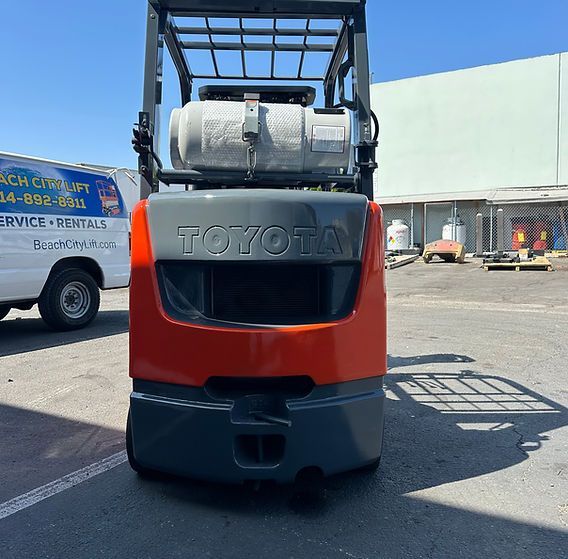 A toyota forklift is parked in a parking lot