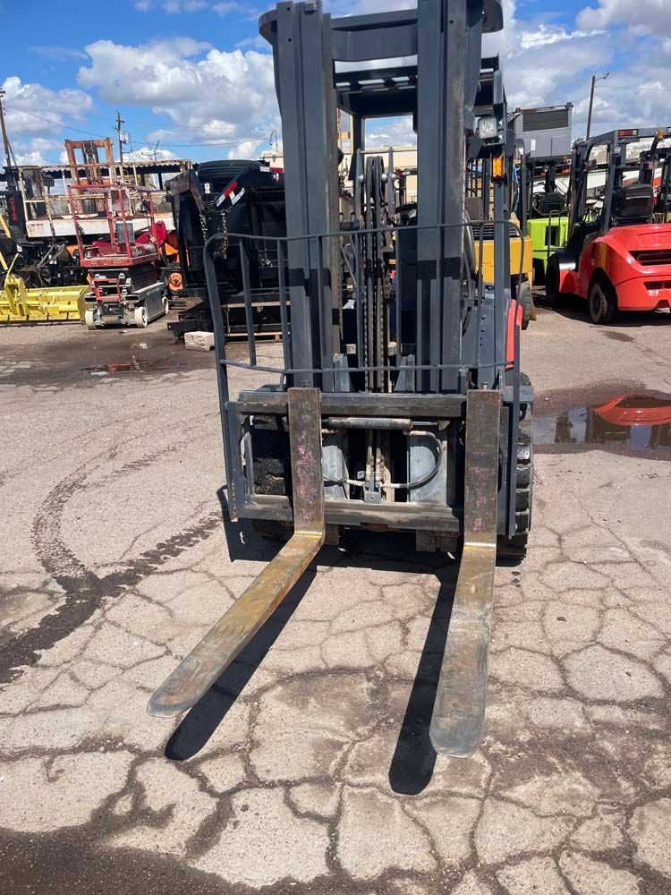 A forklift is parked in a parking lot