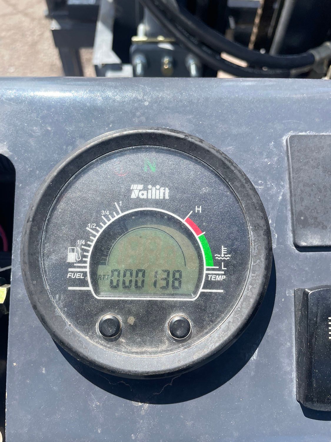 A close up of a gauge of a forklift machine.