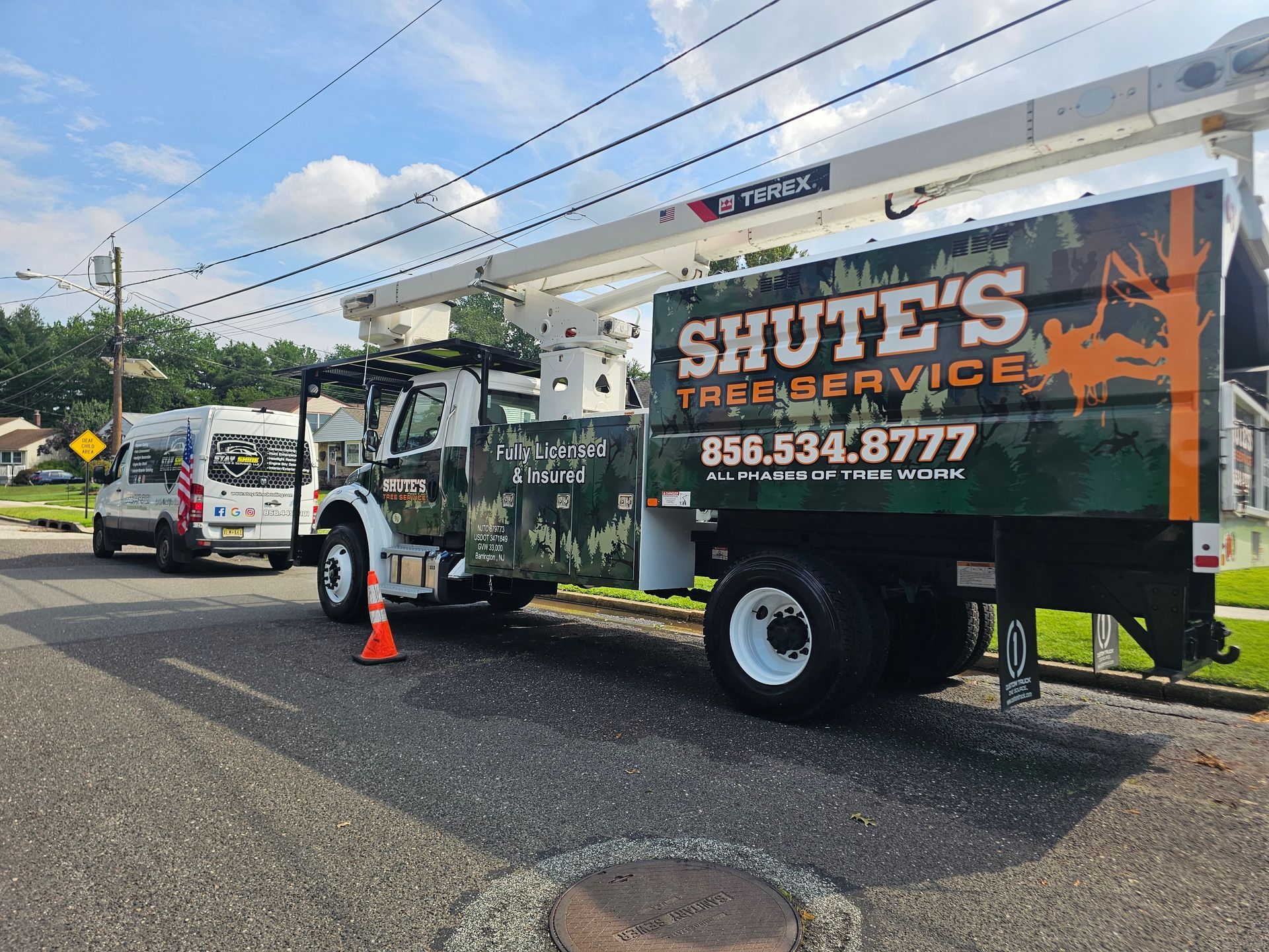 Tree service truck parked on a street; 