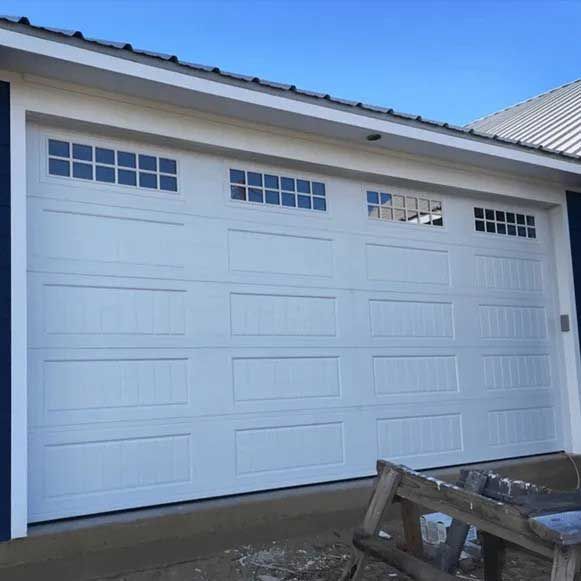 White garage door with rectangular windows at top, blue trim.