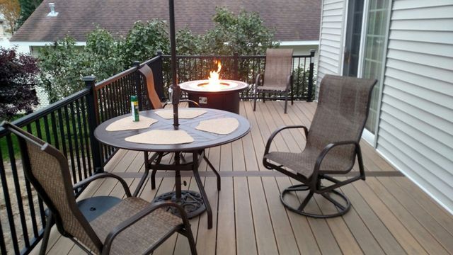 Deck with a fire pit and seating; evening setting.