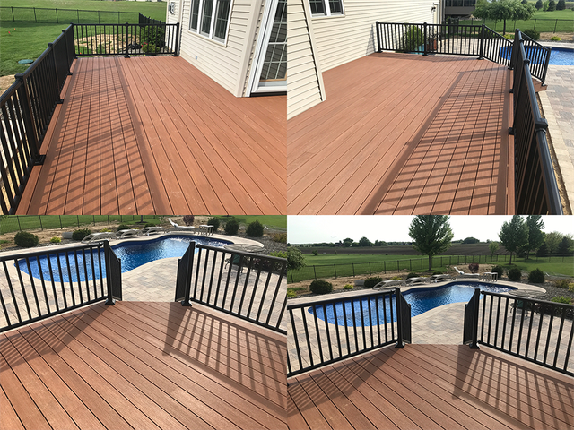 Composite deck with black railing overlooking a yard and pool.