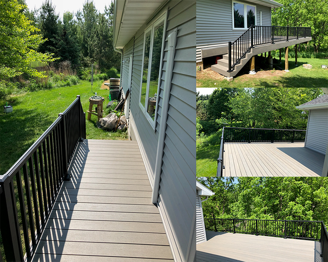 Composite deck with black railing and light gray siding, surrounded by lush green trees.