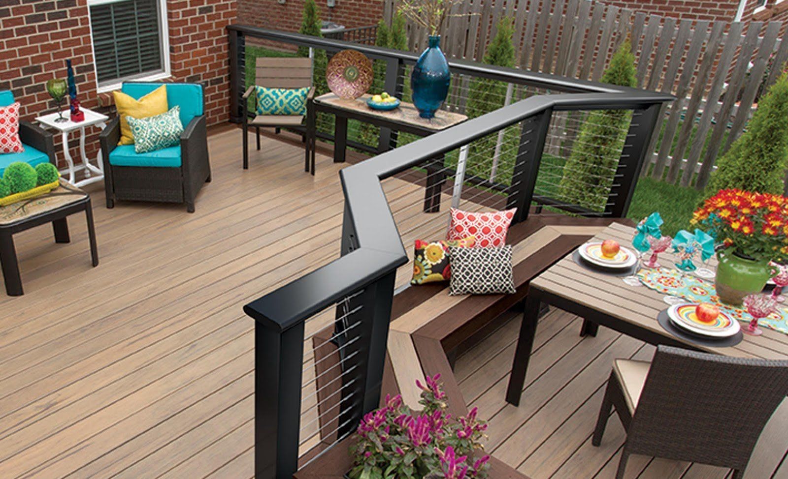Outdoor deck with seating, dining area, and black railing.