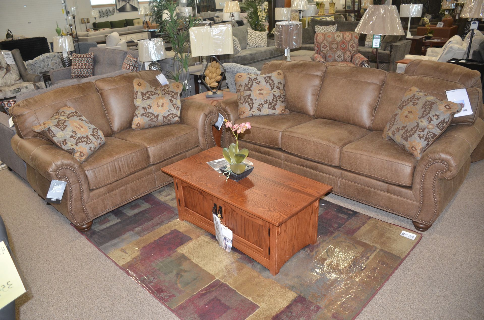 A living room with two brown leather couches and a coffee table.