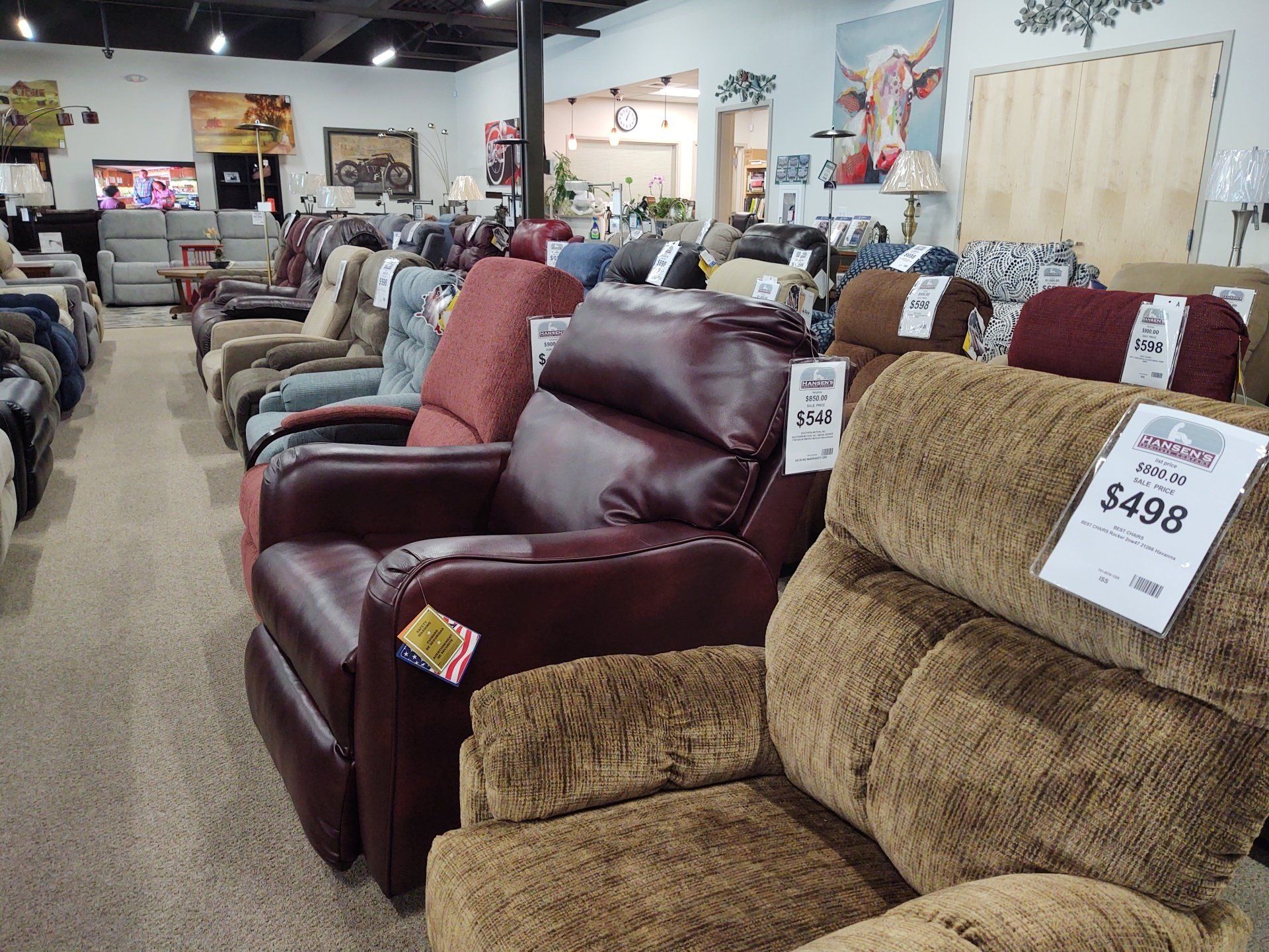 A row of recliner chairs with a price tag that says $498