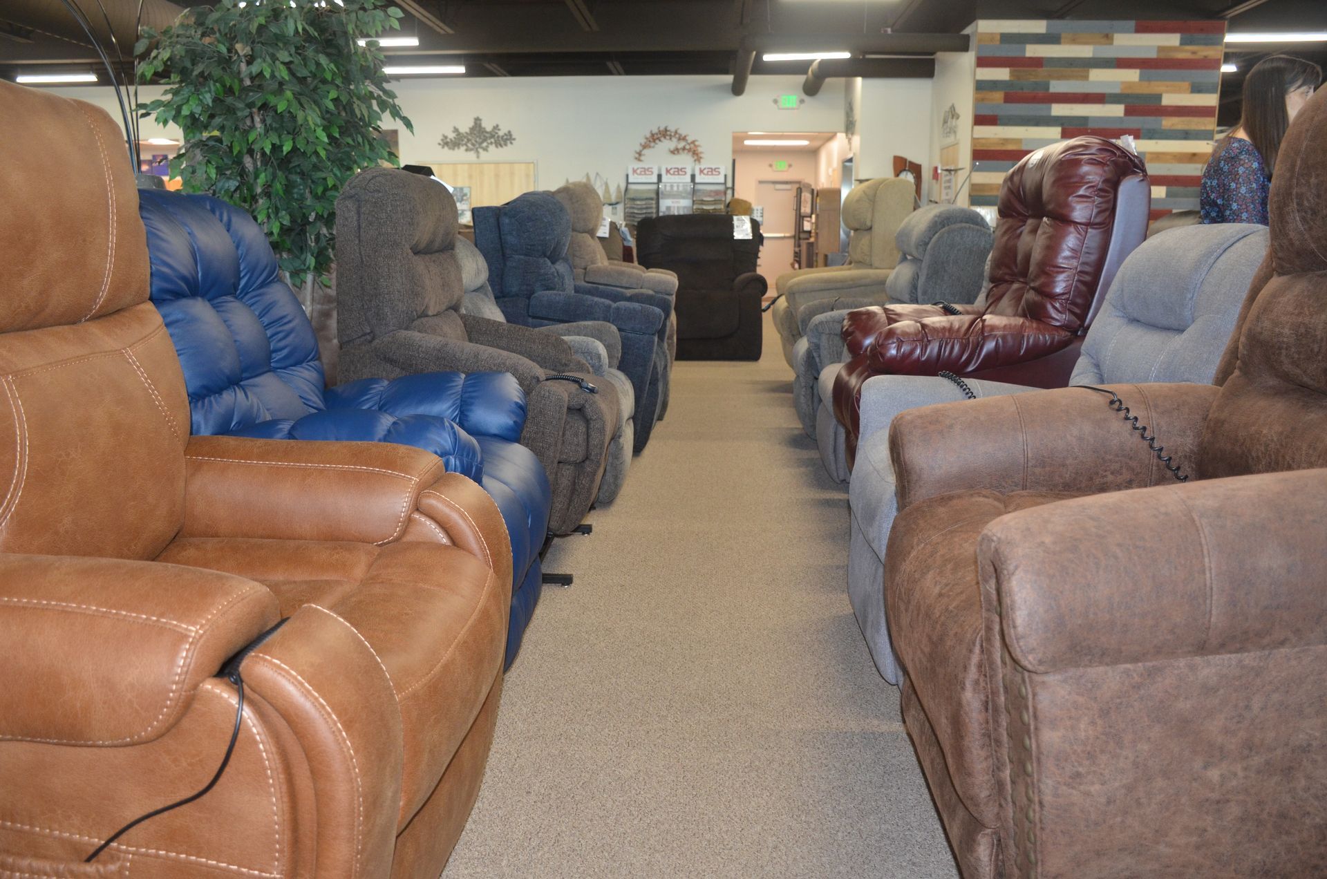 A row of recliner chairs are lined up in a store