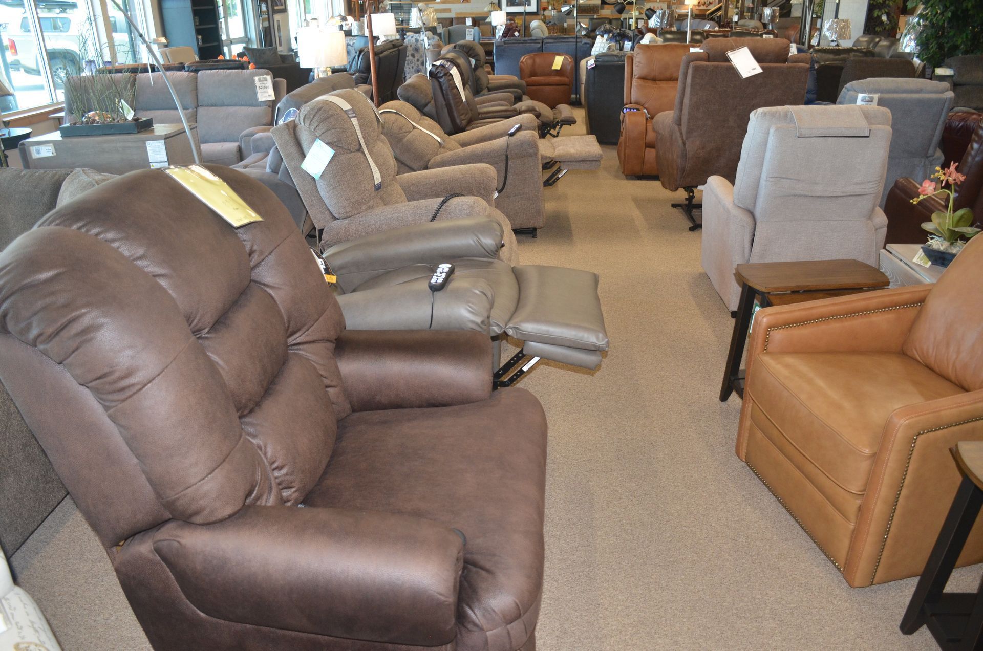 A row of neat-looking recliner chairs are lined up in a store