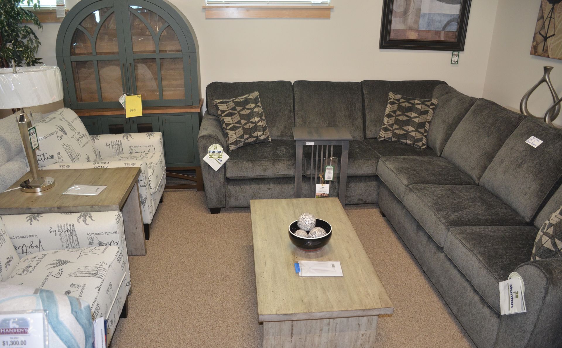 A living room with a sectional couch and a coffee table