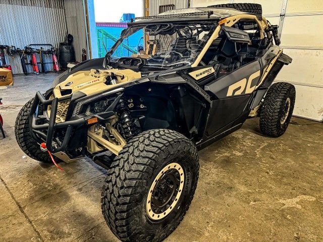 A black and gold ATV is parked in a garage