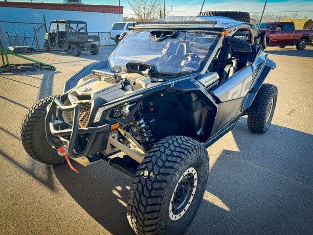 A black and silver ATV is parked in a parking lot