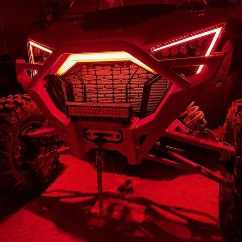The front of an ATV is lit up with red lights