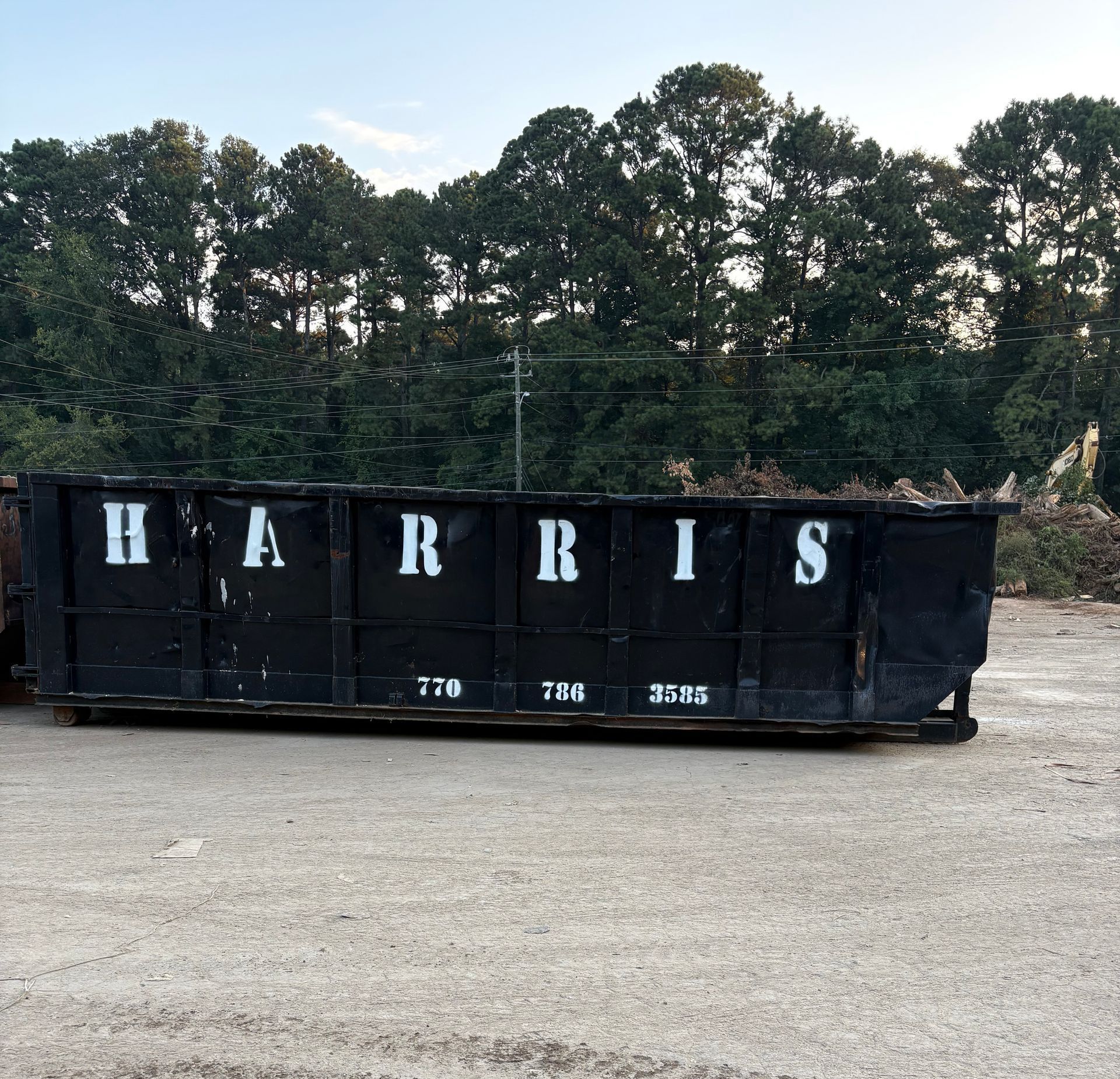 Black dumpster labeled 