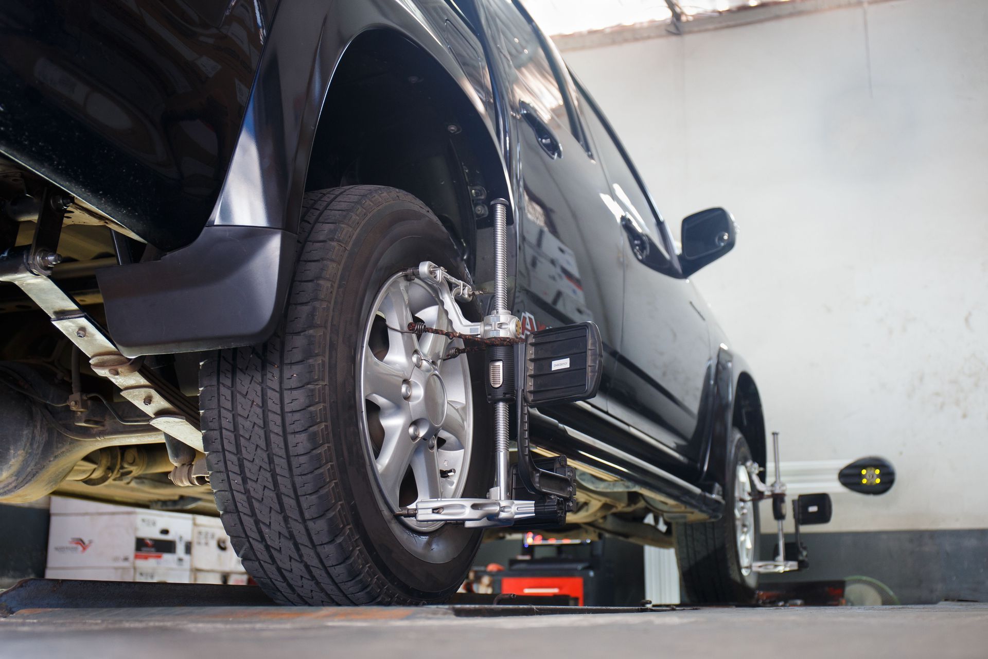 A truck is being aligned in a garage with a machine.
