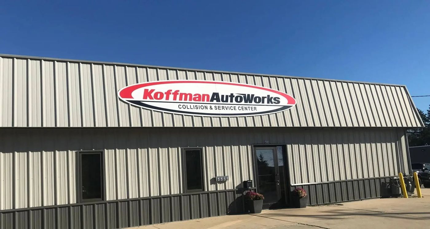 A building with a sign that says koffman autoworks on it