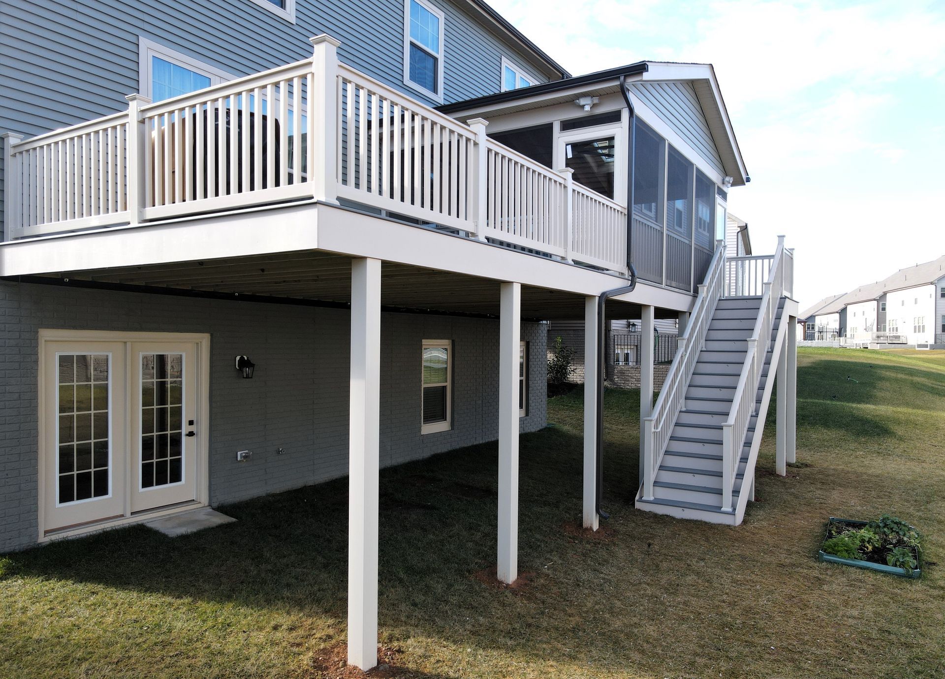 a house with a screened in porch and stairs