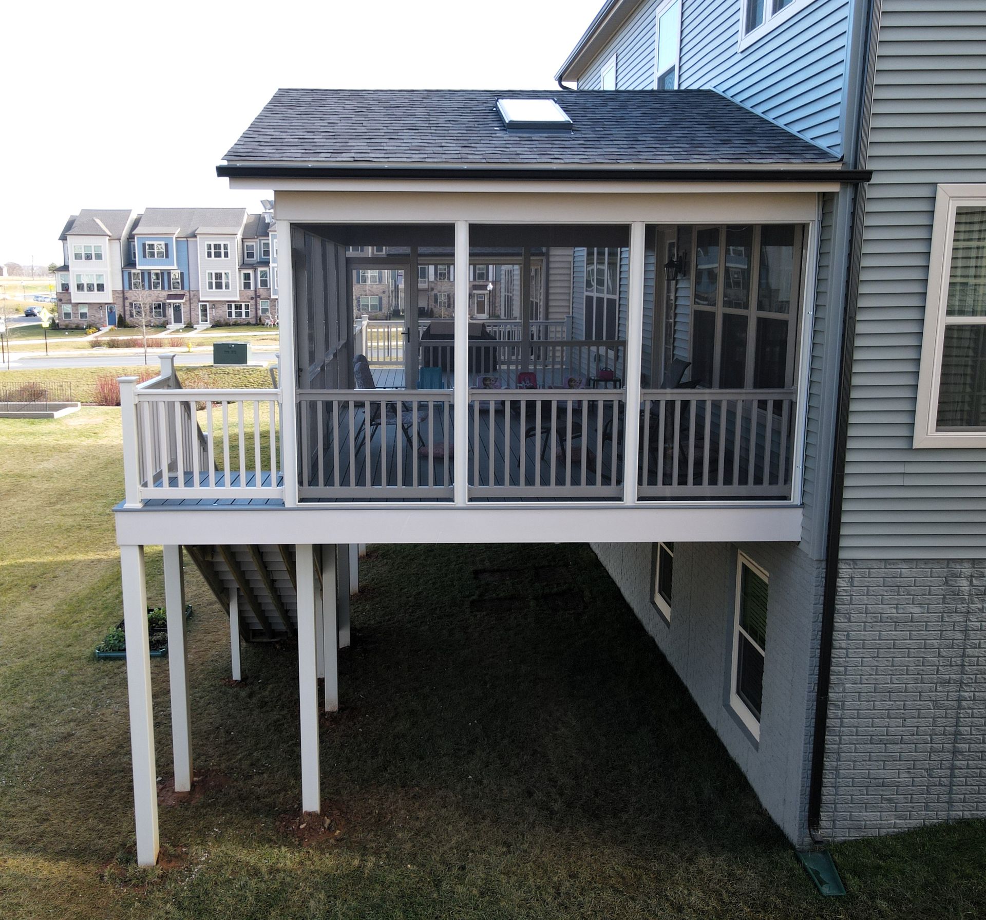 a screened in porch on the side of a house