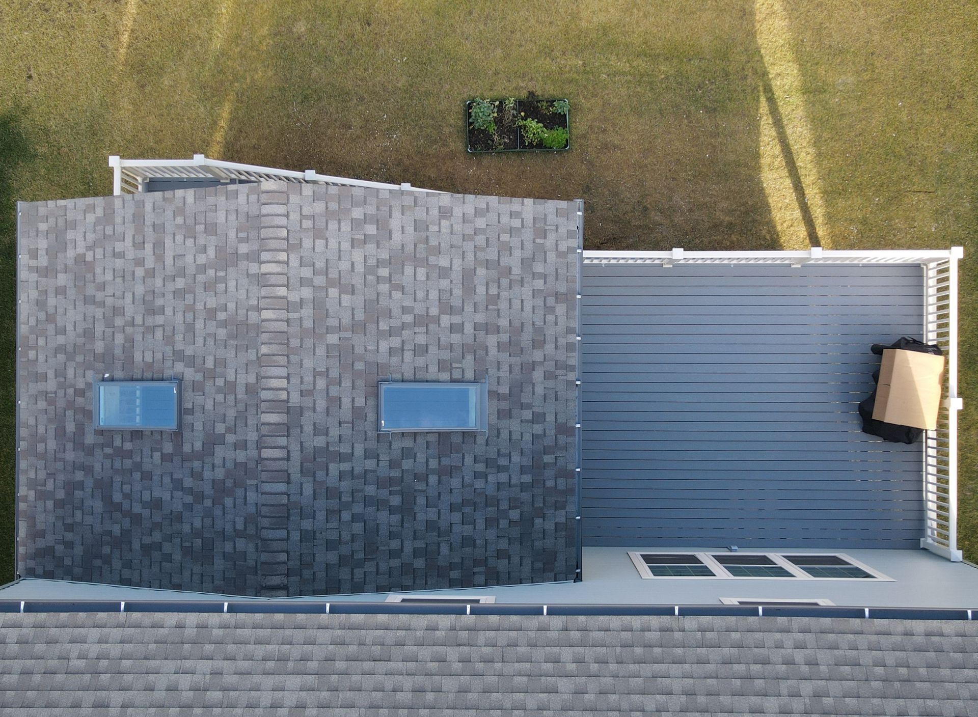 an aerial view of a house with a deck and two windows