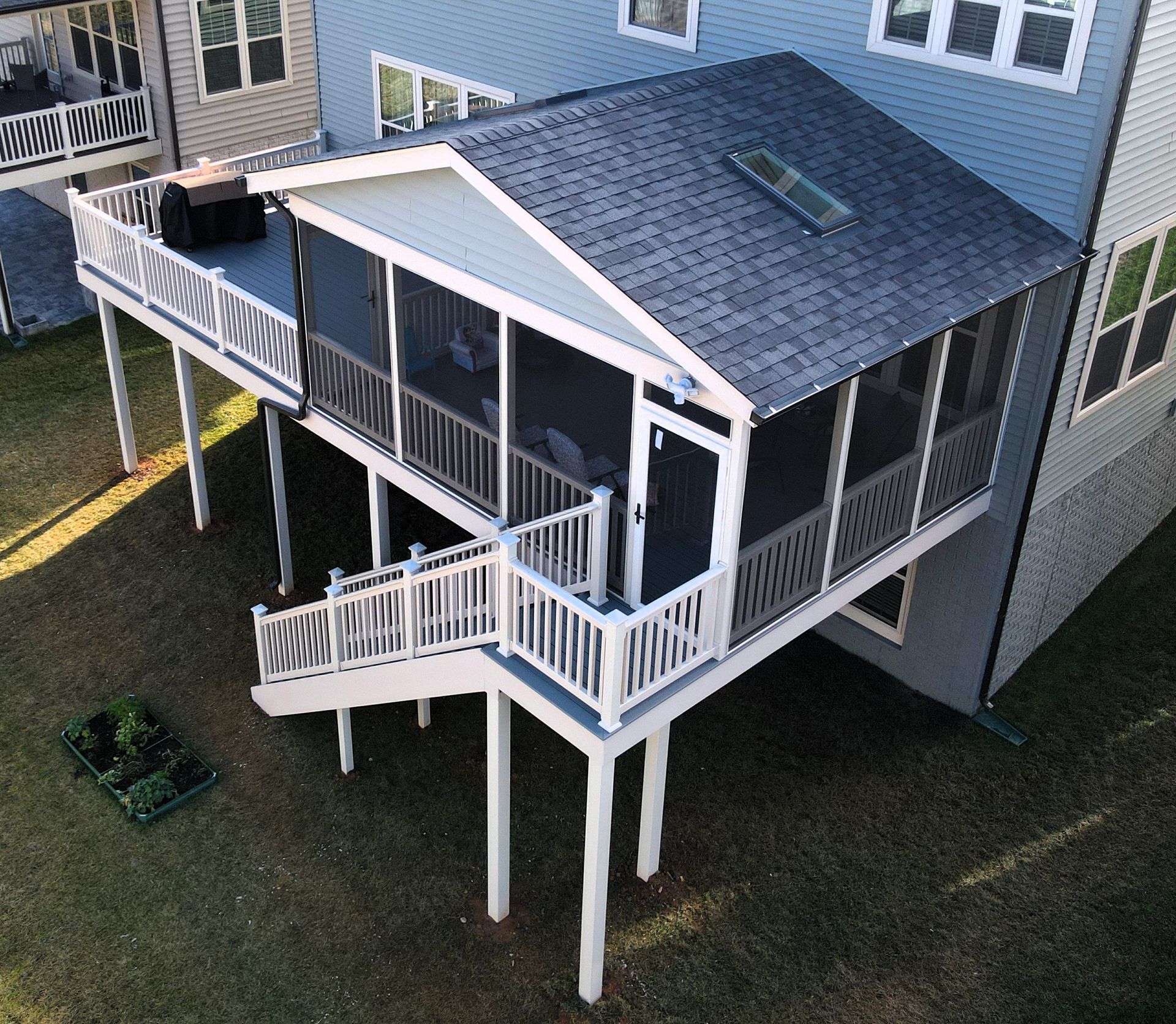 an aerial view of a screened in porch on the side of a house
